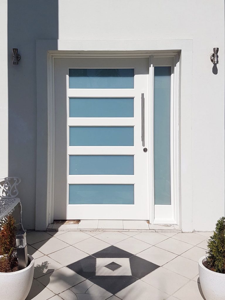 wide frosted glass entry door painted white with matching sidepanel