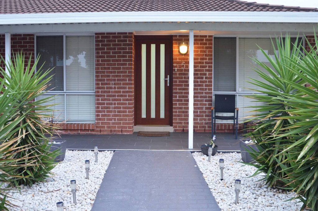 frosted glass front door with vertical panels of safeglass