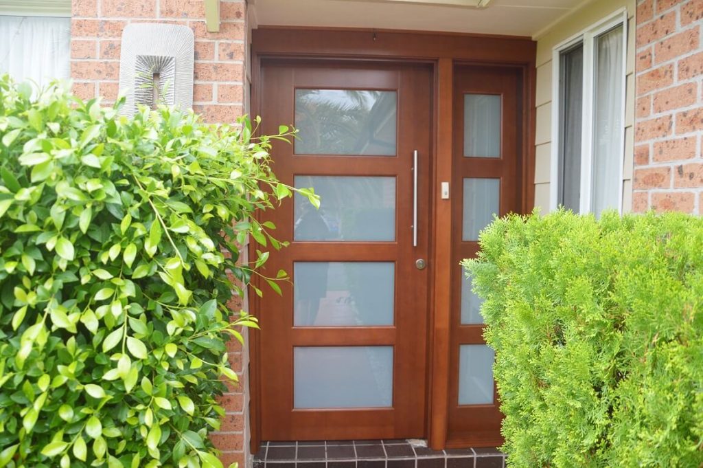 frosted glass front door with matching side panel in solid timber