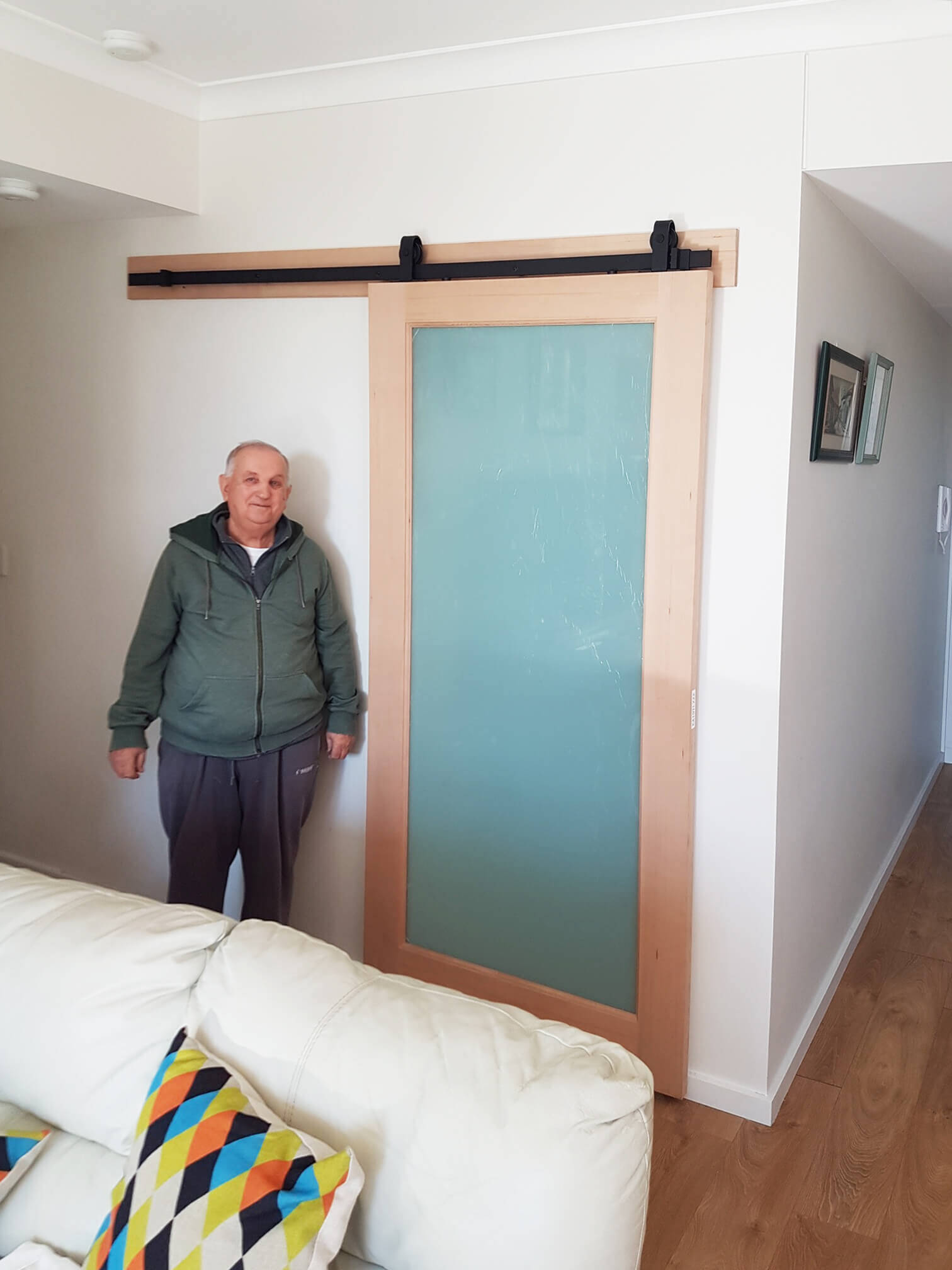 Doors Plus - Mascot Timber Door Installed in Barn Tracks - Featuring Translucent Glass