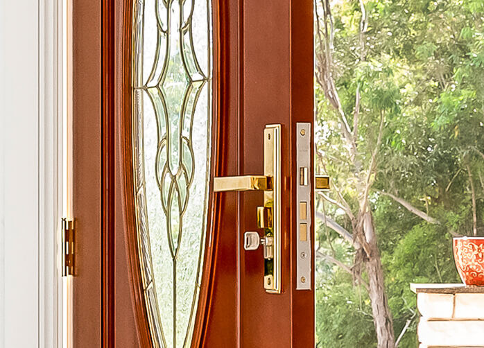 https://www.doorsplus.com.au/wp-content/uploads/2021/05/Doors-Plus-External-Entrance-Flinders-Stained-in-Dark-Maple-doors-with-304-grade-Polished-brass-finish-with-mortice-lock-on-it.jpg