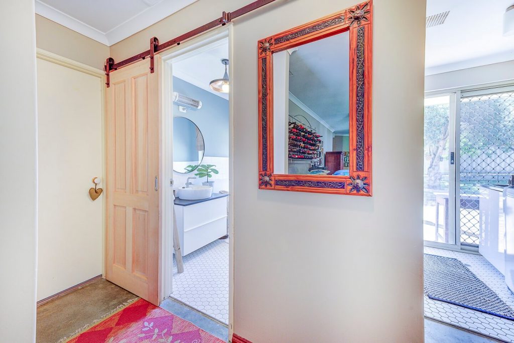 sliding barn door leading into bathroom