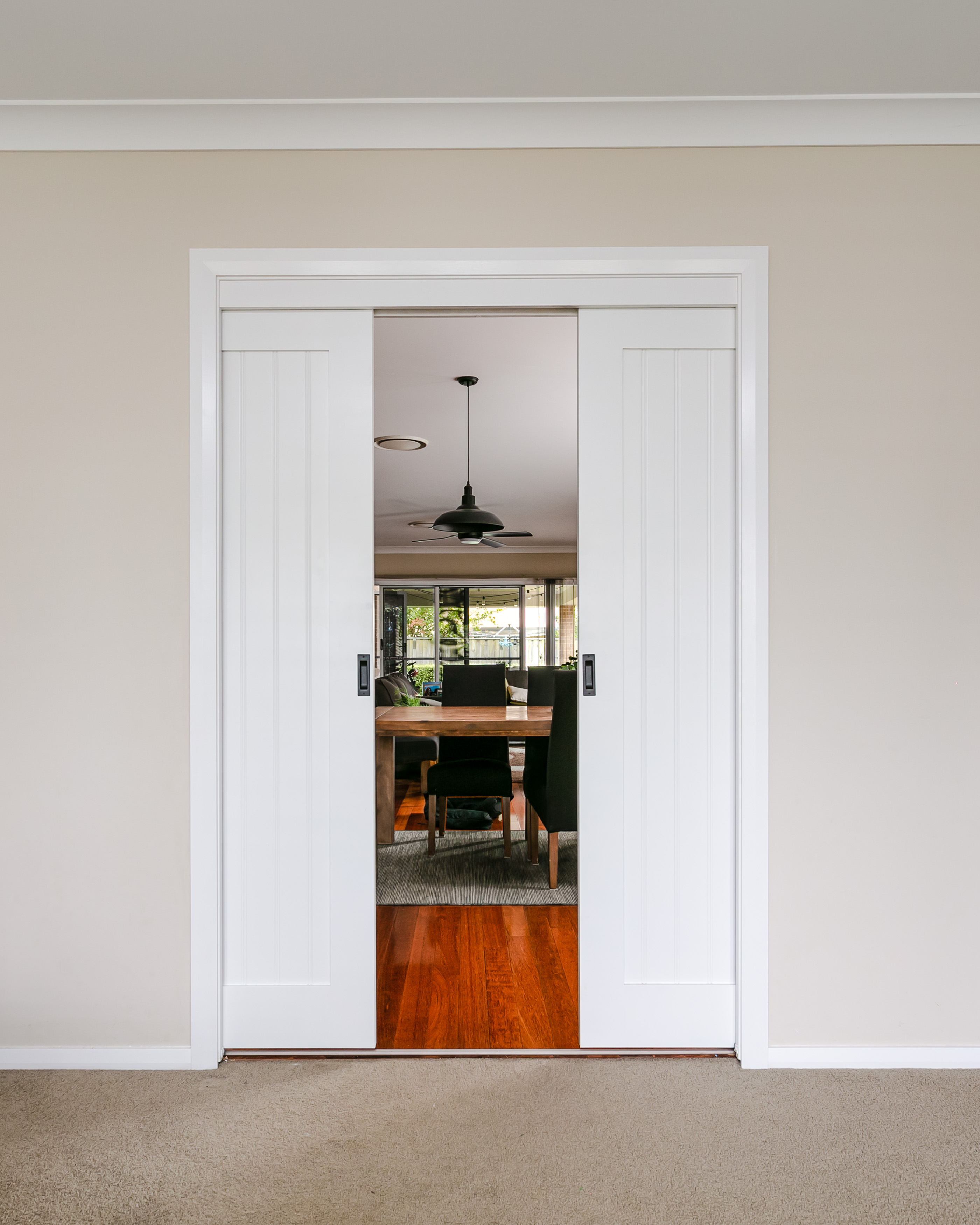 Internal white sliding door separating dinning area