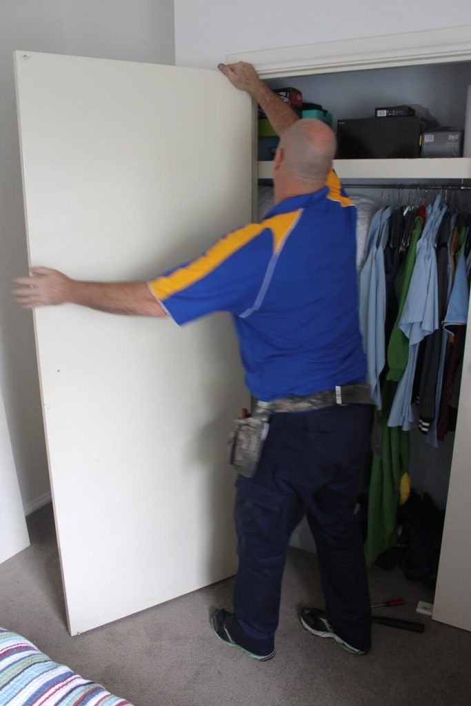 carpenter holding and removing internal door