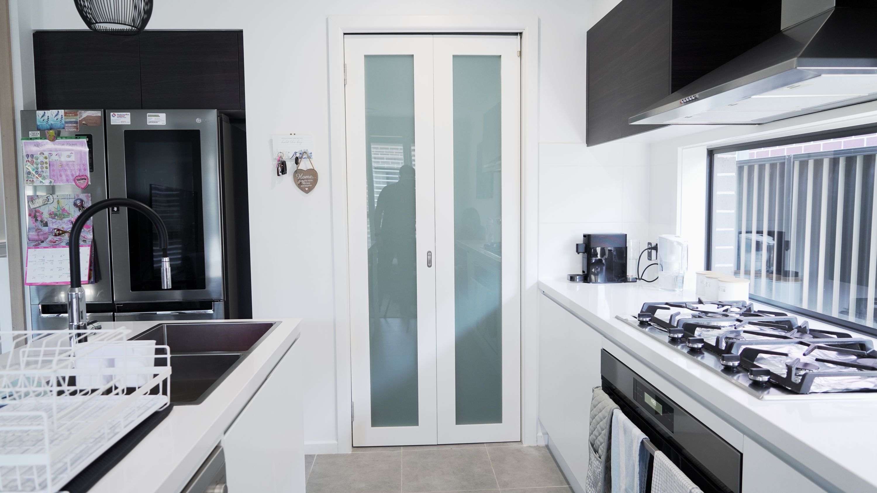 2 Panel bifold door with translucent glass in pantry painted white