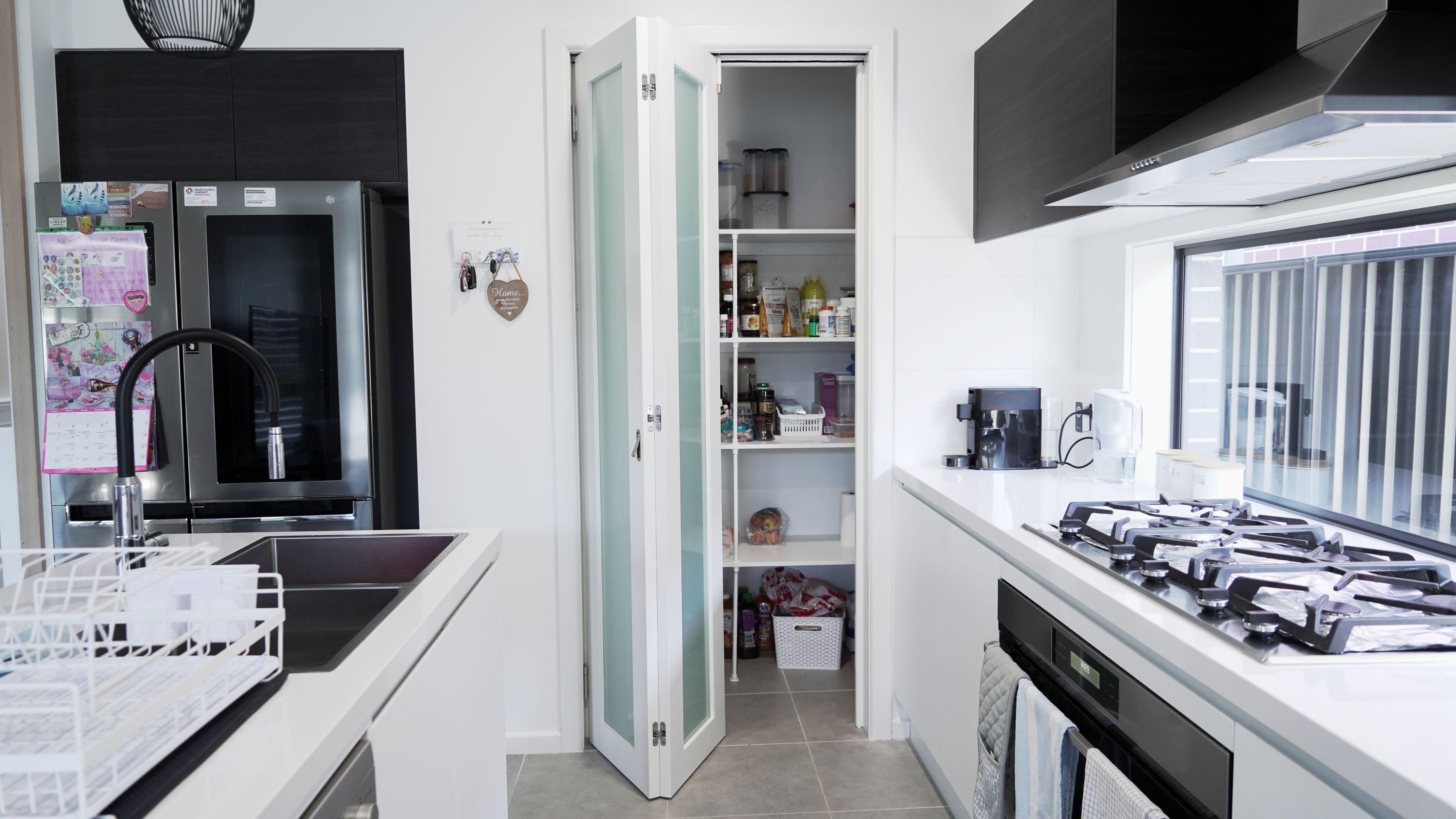 Bifold door with translucent glass painted white in kitchen pantry