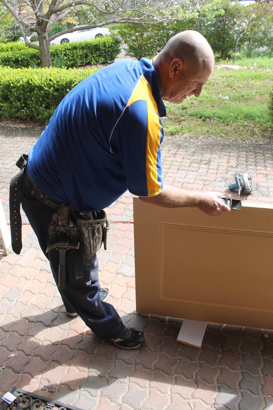 carpenter cutting door to reduce size