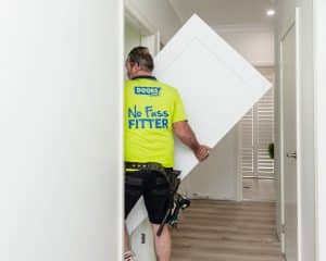 Doors Plus Installer Carrying White Door