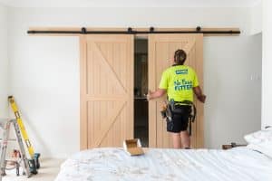 Doors Plus - Installer Mounting the Slider Door on the Track