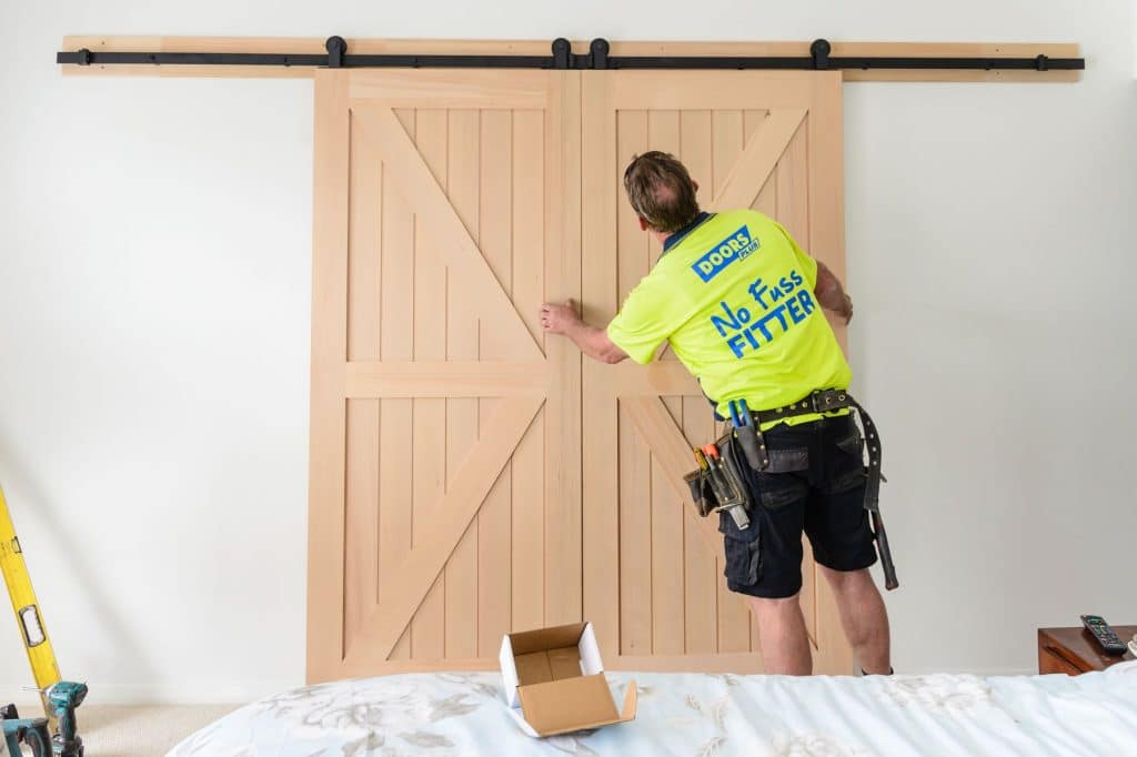 Doors Plus - Installer Mounting the Slider Door on the Track