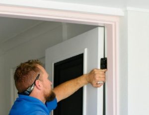 Doors Plus - Man Tightening Hinges for Better Insulation