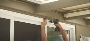 Doors Plus - Carpenter tightening screws