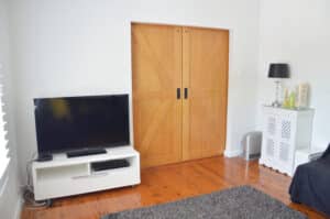 Doors Plus - Double Barn Door in Living Room - Light Maple