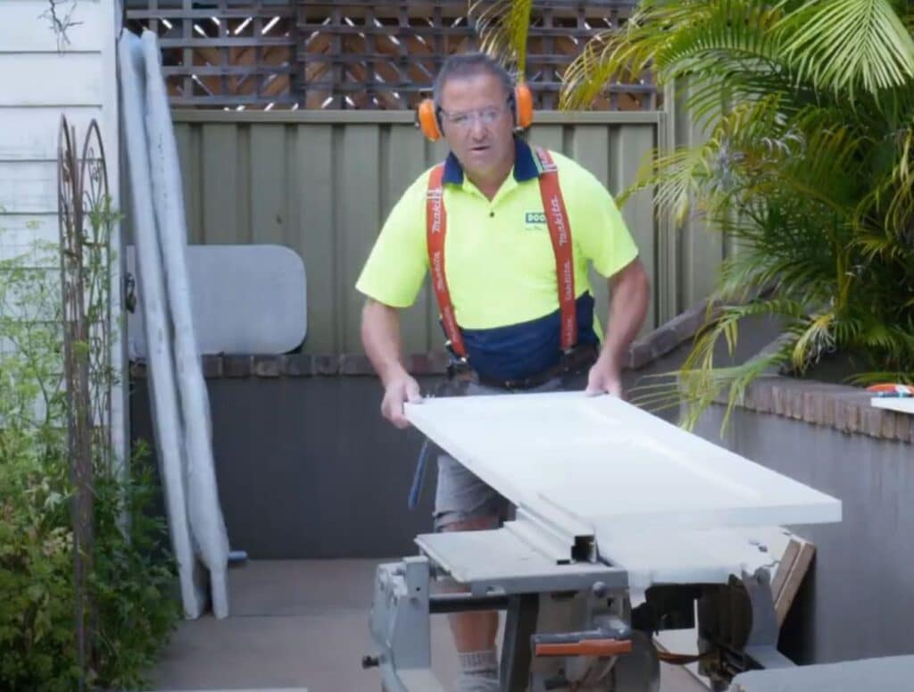 Doors Plus - Installer trimming the door panel with circular saw