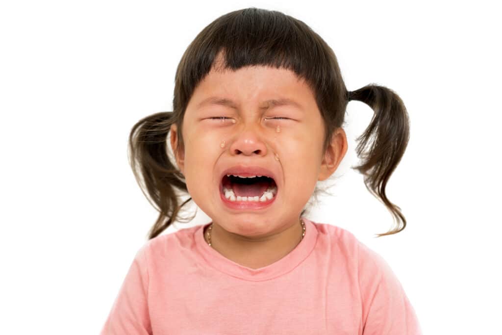 Little asian girl cry on white background