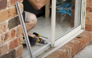 Doors Plus - Fitter Unscrewing the Rollers