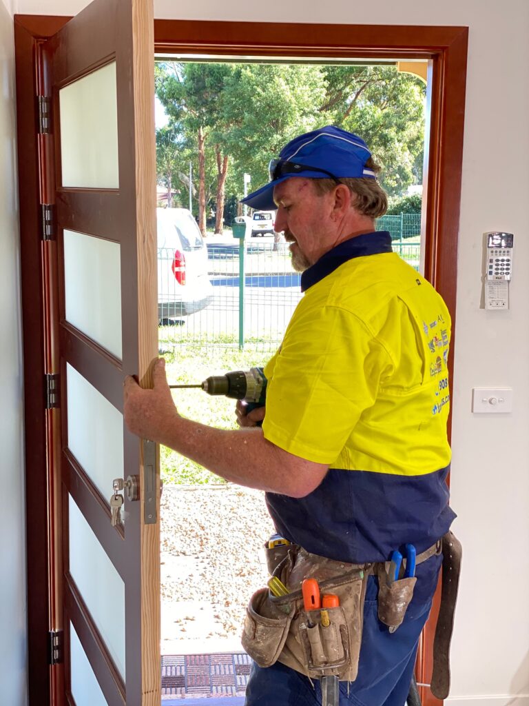 Doors Plus - Professional Carpenter Installing Lock